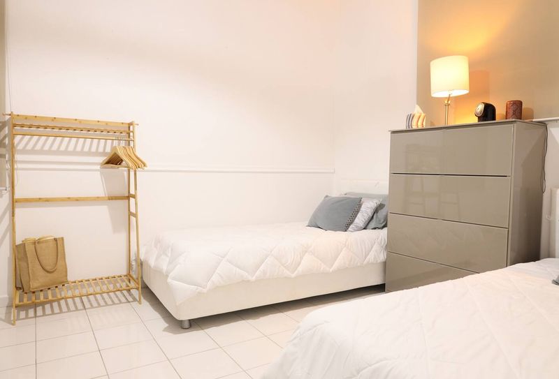 A serene bedroom with twin beds, where comfort meets style.