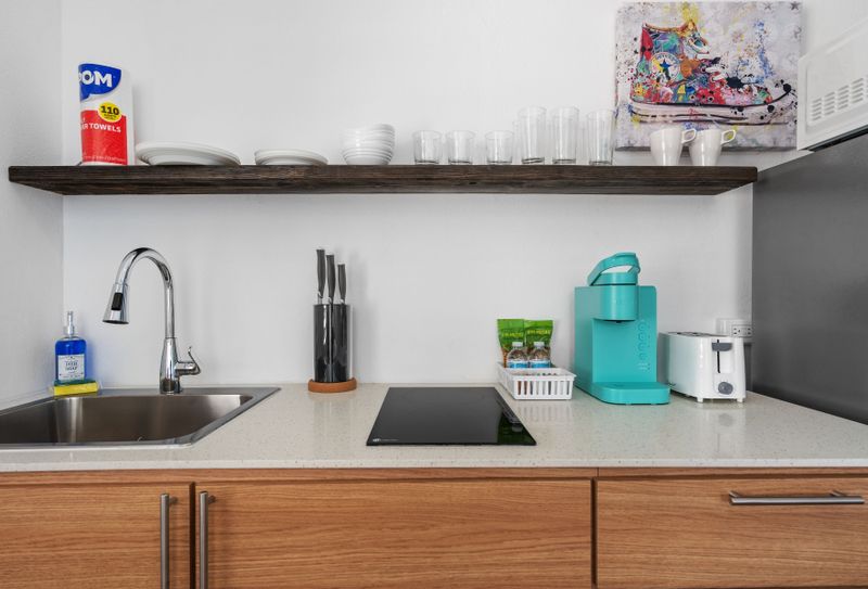 Prepare meals in this well-equipped kitchen with a refrigerator and microwave.