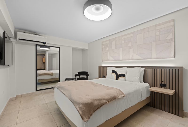 A vintage-inspired bedroom with large mirror.