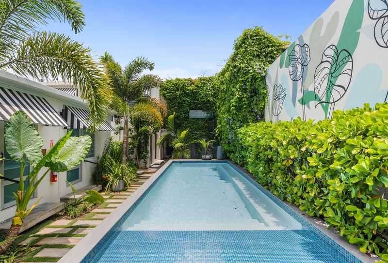 The sparkling pool, outdoor gym, and charming signage create a captivating atmosphere that invites you to explore and play.