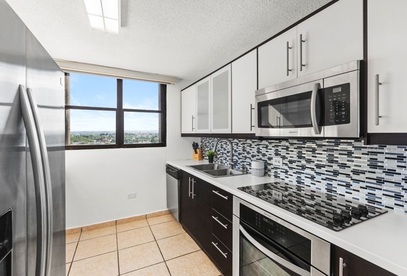 Prepare delicious meals in this generously sized, fully equipped kitchen with high-end appliances for a seamless cooking experience.