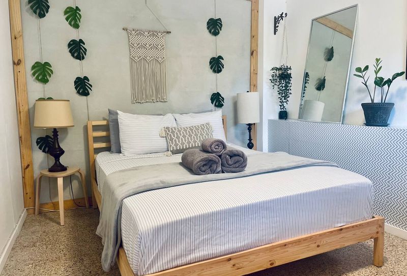 Bedroom: Queen Size Bed, clothing chest, Iron, Smart TV, Wifi, and Air Conditioning.
