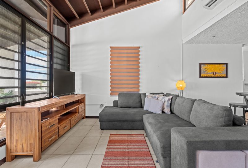 Feel at home in our cozy living space, complete with a comfy sofa, modern TV setup, and plenty of natural light for a serene ambiance.