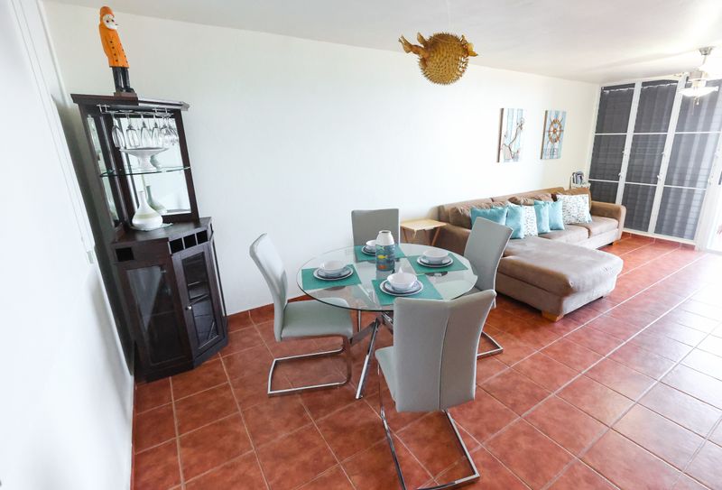 A cozy and inviting dining space with large windows offer ample natural light.