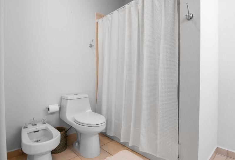 Our pristine bathroom provides a bright and private space for your daily routine, designed for convenience.