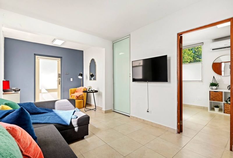 Cacique | Family Vacation Rental 5 Kick back and watch your favorite shows. The living room features a large smart TV and stylish decor for ultimate relaxation and entertainment.
