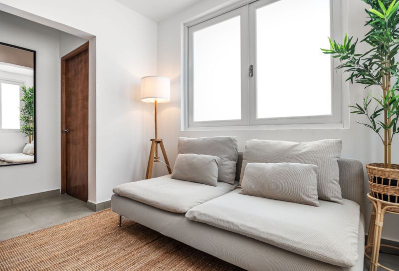 Relax and unwind in this cozy space, featuring a comfortable sofa perfect for lounging or reading.