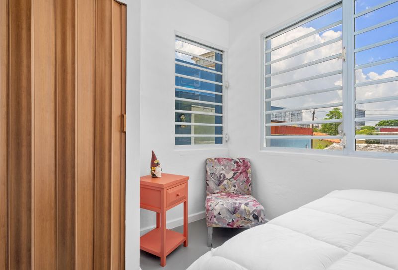 Indulge in the luxury of a queen-sized bed in a sun-filled space.
