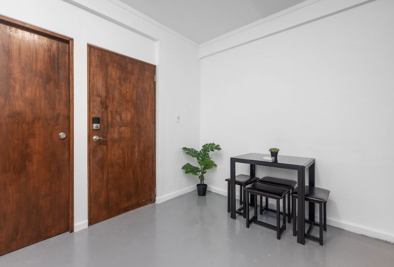 Condado | Puerto Rico Vacation Rental 5 Tasteful Dining Experience: Gather around this stylish dinner table, designed for comfort and conversation, offering the perfect setting to savor delicious meals in a contemporary and inviting atmosphere.