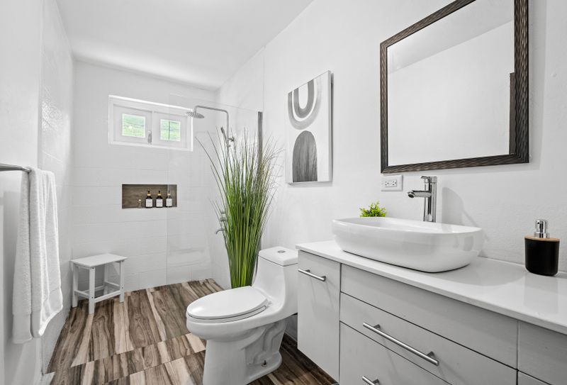 Montmare | Vacation Rental Villa 5 A well-lit bathroom featuring a large mirror.