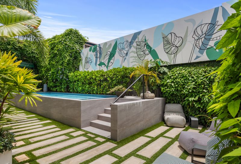 Escape the hustle and bustle in our secluded pool area, complete with lush tropical plants and comfortable loungers.