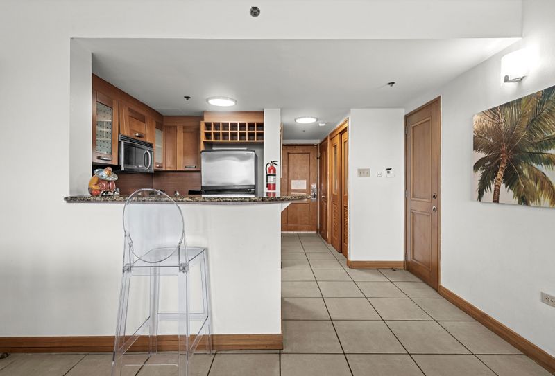 Chic breakfast bar with a clear stool, offering a charming spot for a meal or drink.