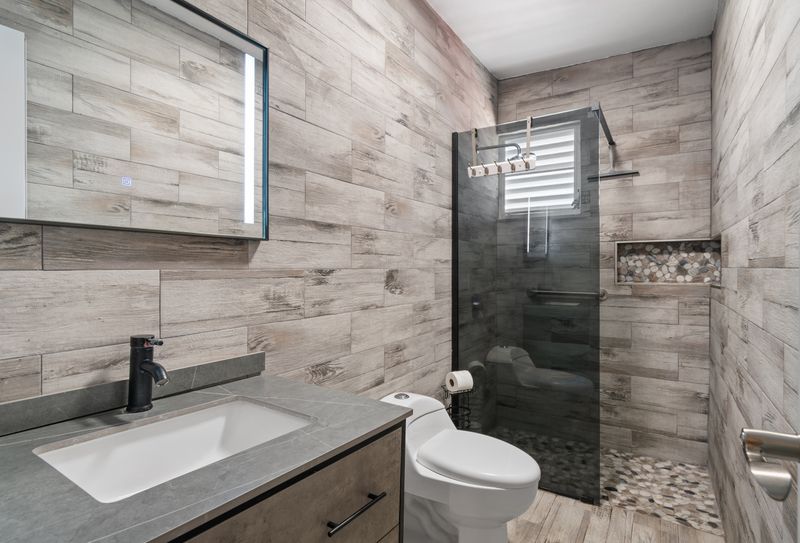 Luxurious bathroom featuring stunning wood-look tile throughout.