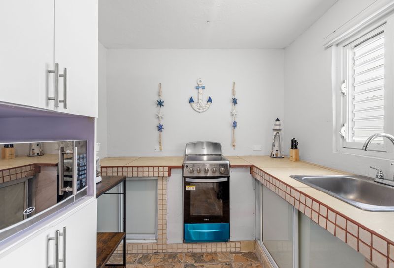 Cook like a pro in this bright kitchen, complete with a fridge, oven, and all the tools you need.
