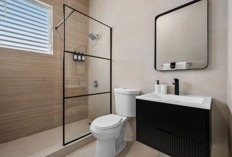 Spacious bathroom with a modern shower and minimalist design.