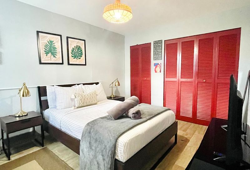 Unwind in comfort! Our spacious bedroom features a plush Queen-sized bed with crisp linens, promising a restful night's sleep after a day of adventure.