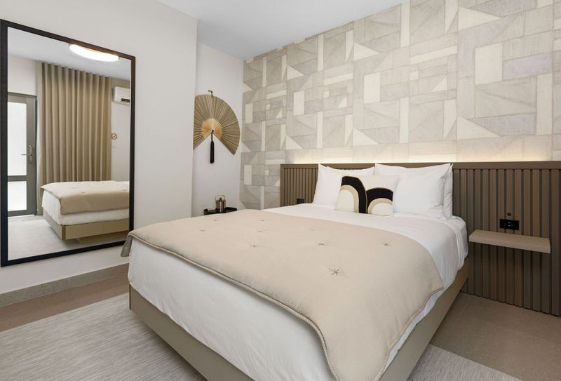 Cozy retreat with soft ambient lighting, highlighting unique geometric patterns on the wall, creating a warm and inviting atmosphere.