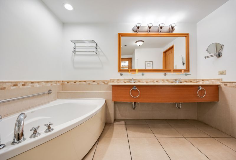 Bright and spacious, our bathroom offers a sophisticated design with beautiful tile accents and a large, well-lit mirror to get ready in comfort.