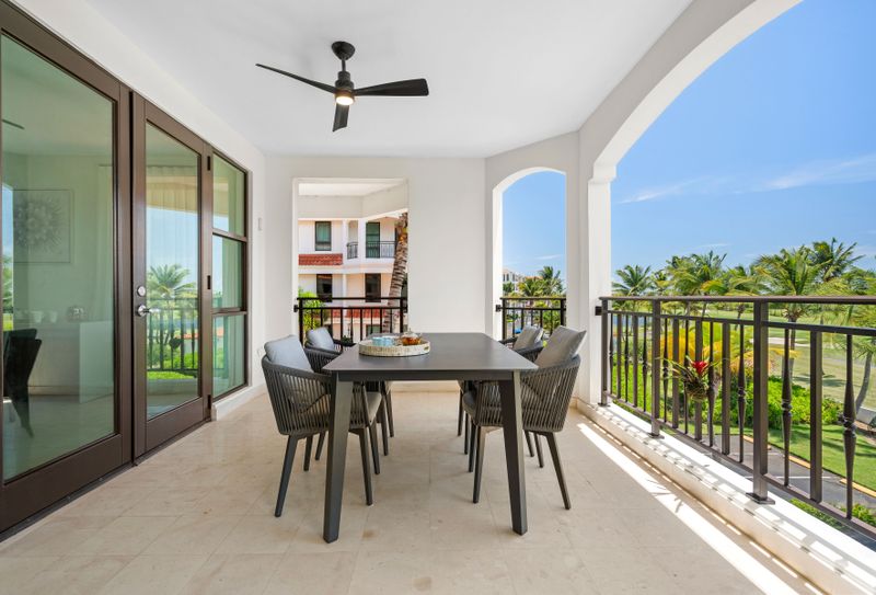Relax on your private balcony with plush seating and a stylish table, and enjoy stunning views of lush greenery and sparkling water. It’s the perfect spot to unwind and soak in the beauty.