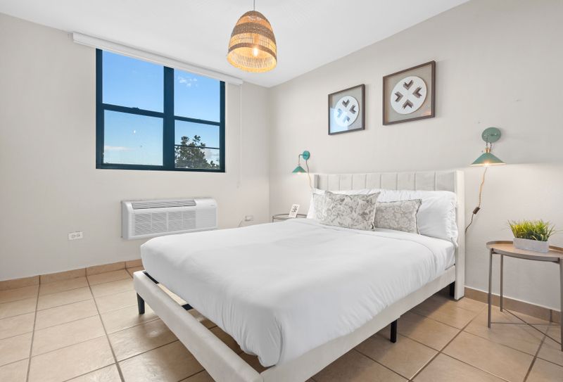 Wake up to the gentle breeze and sounds of the ocean in this bedroom, complete with a cozy bed and plenty of natural light.
