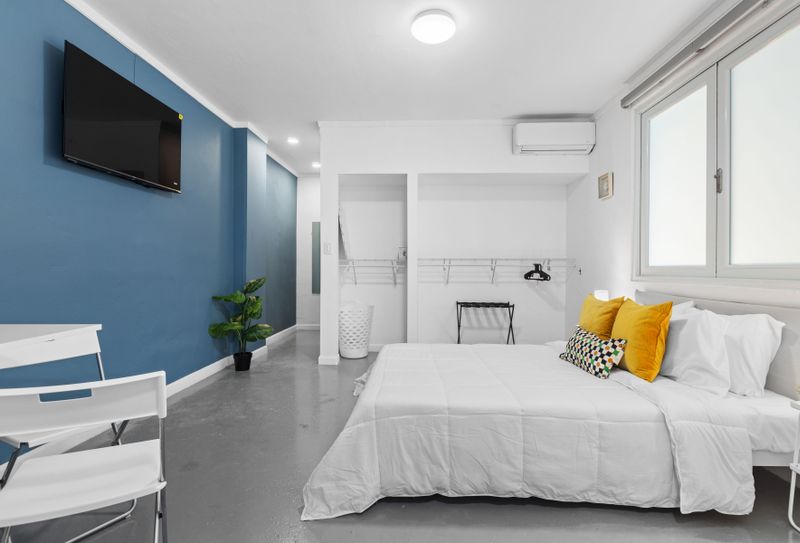 Serene Slumber: Sink into the plush comfort of this queen-sized bed, set against a calming backdrop, promising restful nights and peaceful mornings.