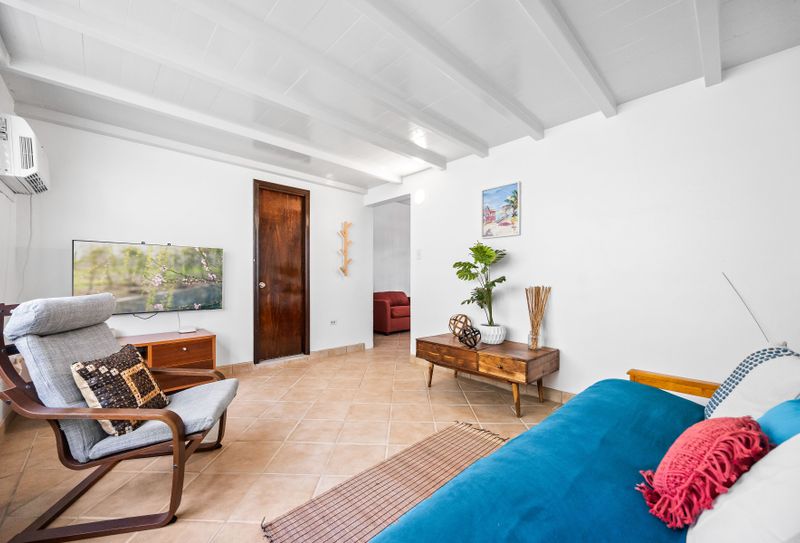 Wind down with your favorite shows in the stylish living room featuring a flat-screen TV and plush seating.