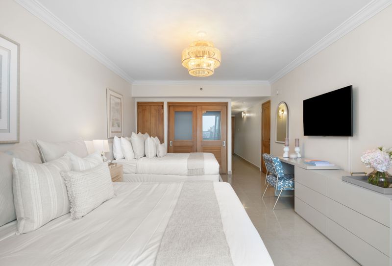Your peaceful retreat awaits. A comfortable bedroom with direct balcony access.