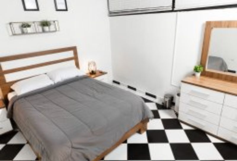 Indulge in peaceful slumber in this elegantly appointed bedroom. A comfortable queen-sized bed, stylish bedside tables with soft lighting, and captivating wall art create a serene and inviting atmosphere. Your perfect night's rest awaits.