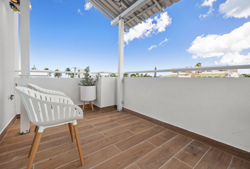 Wake up to the serene views of the cityscape from this cozy balcony!