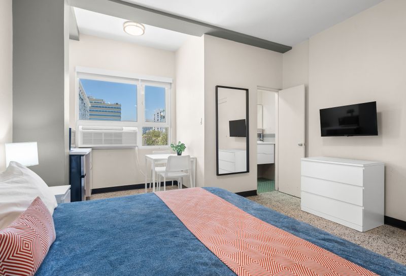 Enjoy the convenience of a dedicated workspace and a comfortable bed.