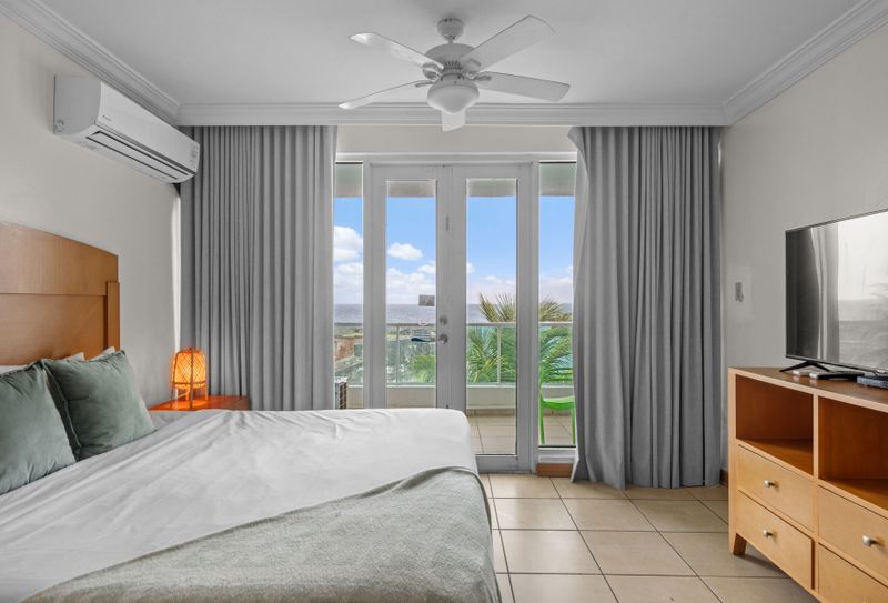 Your tranquil oasis awaits. This spacious studio bedroom connects seamlessly to your private balcony, offering refreshing breezes and stunning water vistas for a truly relaxing stay.