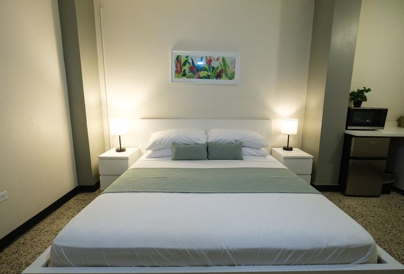 Experience peaceful sleep in our meticulously prepared bedroom, featuring a comfortable bed with fresh linens and soft lighting for a truly restful stay.