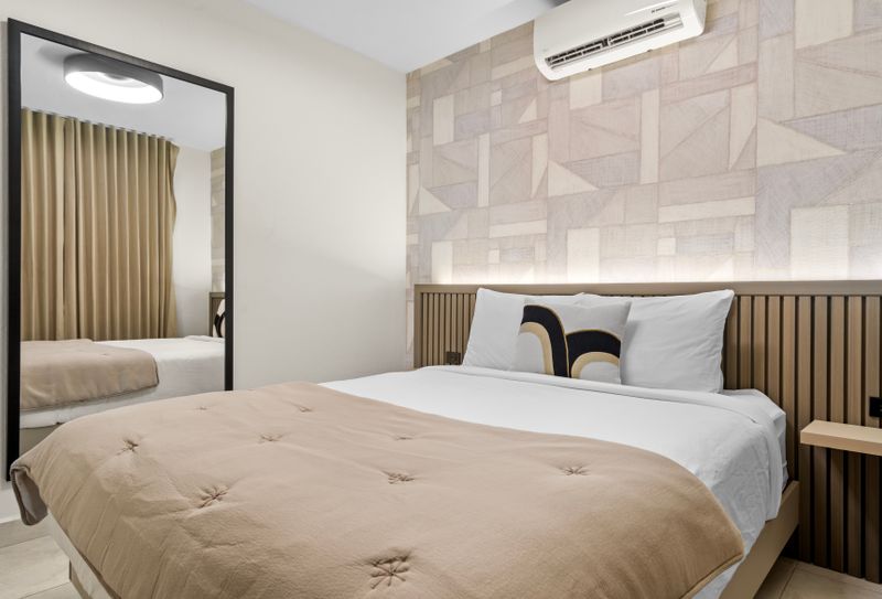 Unwind in style in our spacious and comfortable room, featuring a plush bed and a calming atmosphere.