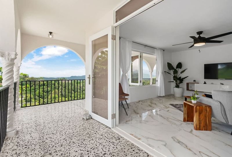 A spacious open-plan living area with marble flooring.