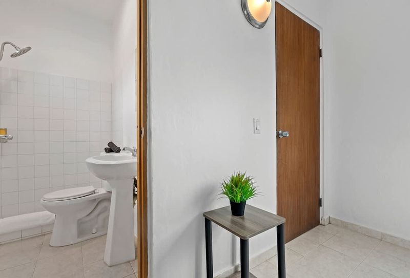 Indulge in comfort with a brightly lit bathroom furnished with modern decor.