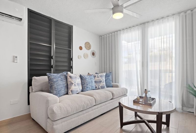 Our living room, designed for ultimate relaxation, features a plush sofa and soft throws.