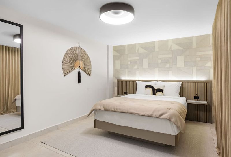 The Weekender | Standard Room 3 Modern headboard with warm wood accents adds a touch of elegance.