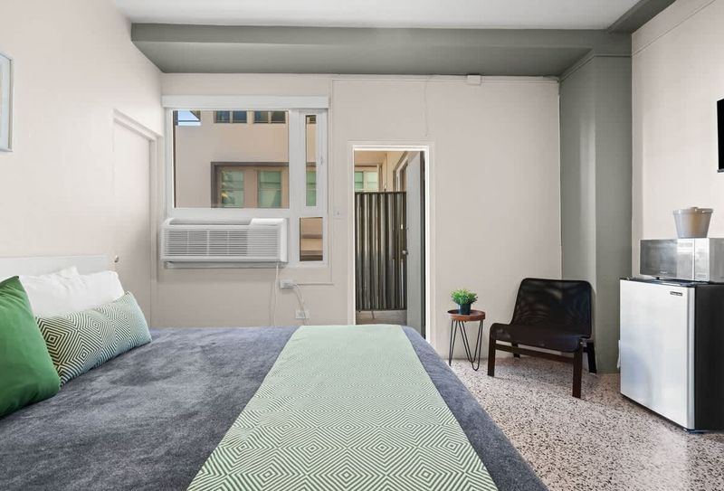 Olimpo | Hotel Room With Balcony 3 Sink into the ultimate comfort of our inviting bed, complete with soft pillows and crisp linens, promising you a truly restful and dream-filled night.