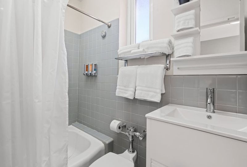 Our spotless bathroom provides all the essentials for your comfort, including fresh, soft towels, and a sparkling clean shower area to refresh and rejuvenate.