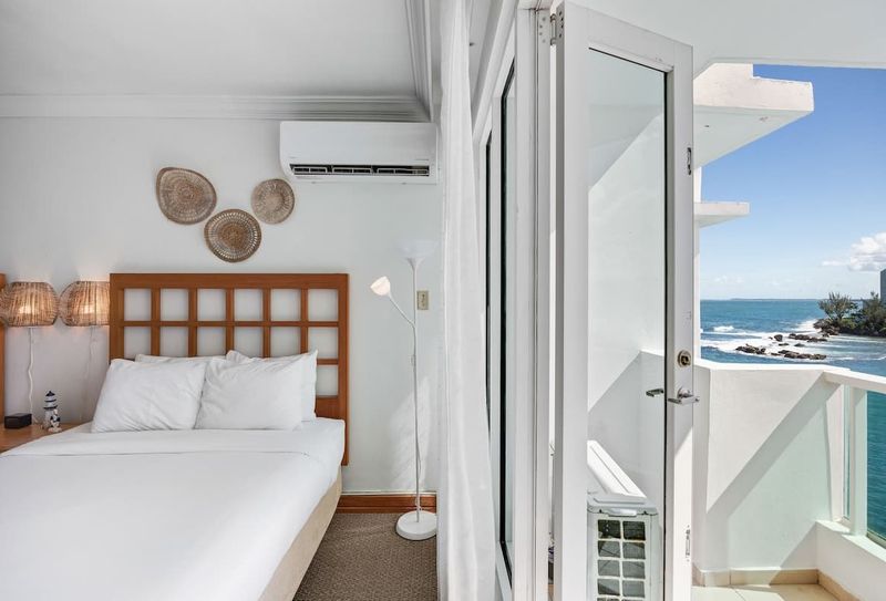 A serene bedroom that opens directly to a balcony, where the beach becomes your personal paradise.