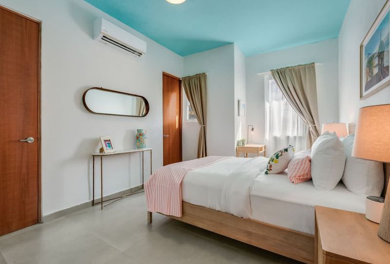 A sizable sleeping space with a wide window and a brand-new bed.