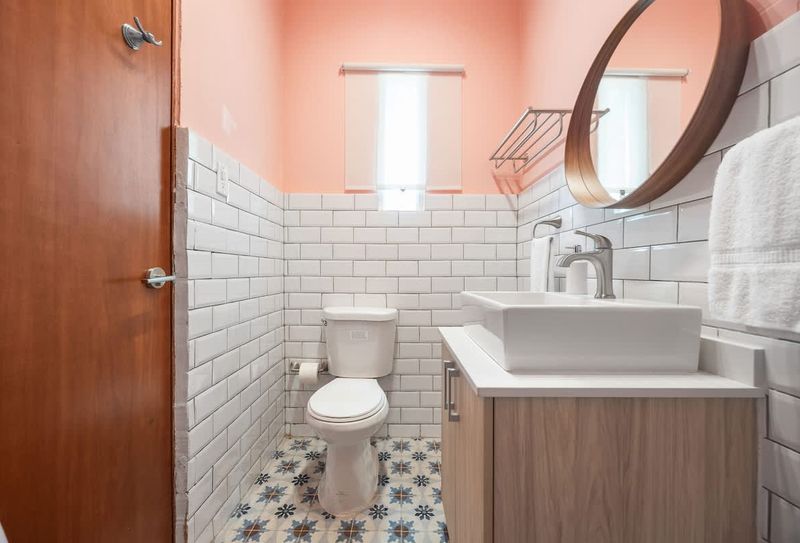 A tidy and sleek bathroom with a large mirror, great for getting ready.