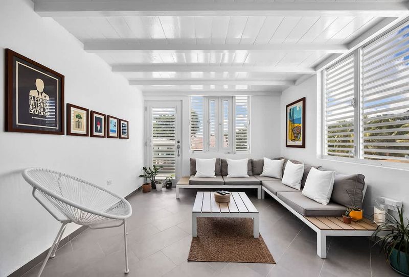 Relax in the inviting living space, complete with a comfy sofa and a bright window that fills the room with daylight – perfect for reading, lounging, or streaming your favorite shows.