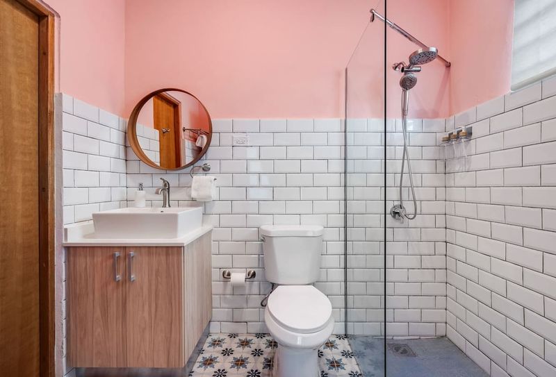 Stylish bathroom with a vanity mirror and a relaxing rain shower.