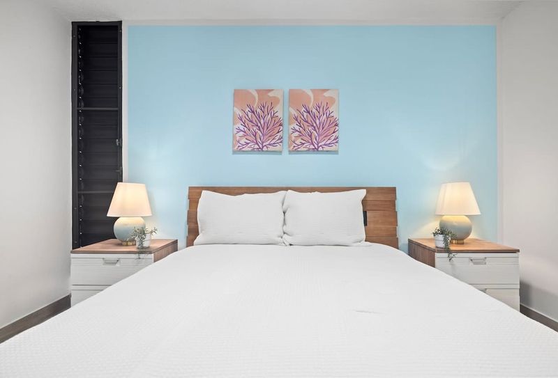 Plush queen bed, stylish nightstands & captivating art. Your serene sleep sanctuary.