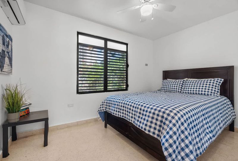 Near Luquillo Beach | Free Parking | Air Conditioner 5 Light & airy: A tranquil space with charming island shutters.
