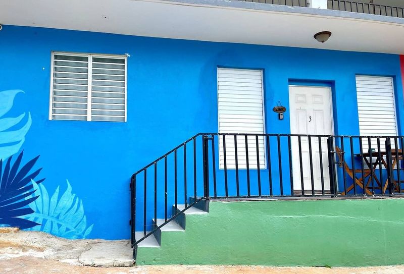 Spacious Eco Retreat | Solar-Powered 5 Step into serenity! Our private entrance, framed by a charming blue staircase, offers a welcoming and secure entry to your exclusive apartment.