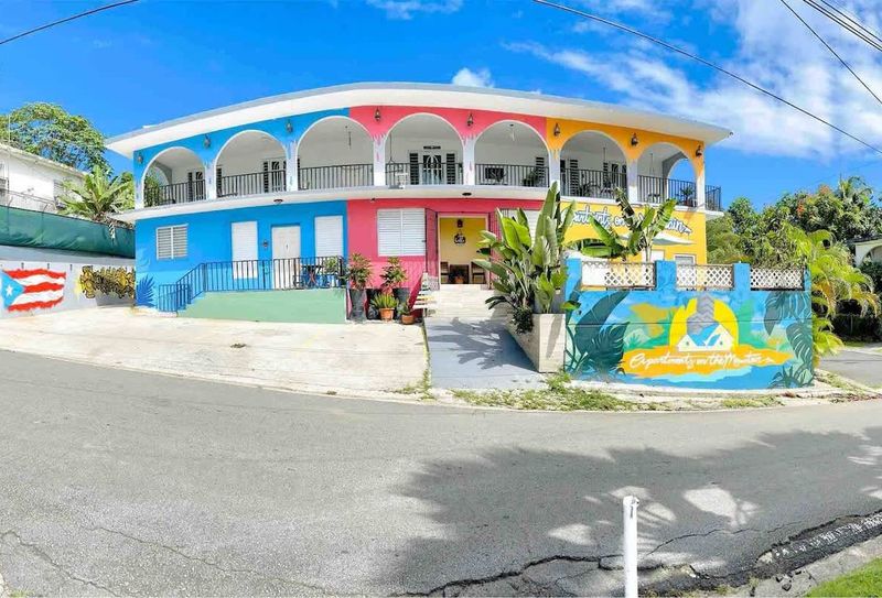 Discover the vibrant charm of our property's exterior! With its cheerful colors and inviting atmosphere, you'll feel the spirit of the island the moment you arrive.