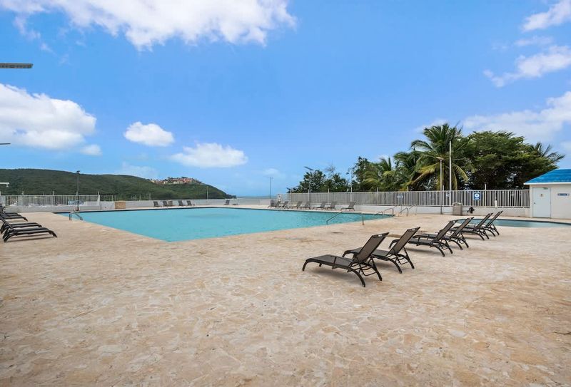 Marina | Beachfront Rental 5 Dive into refreshment! Our sparkling communal pool invites you to cool off and relax under the Caribbean sun, surrounded by lush tropical landscaping.