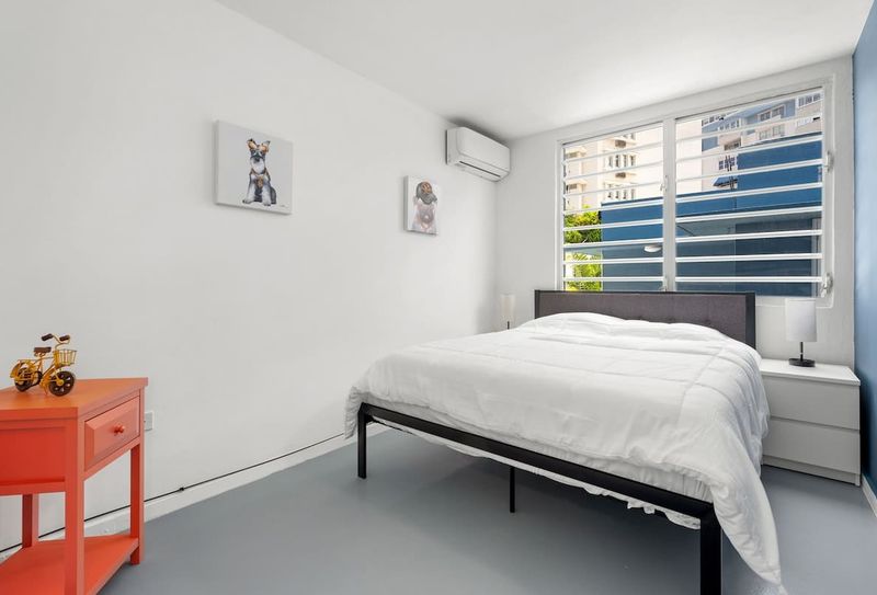 Condado | Near The Beach Condo 5 Find solace in this tranquil bedroom equipped with air conditioning for those warm days and nights - your cool oasis amidst the urban jungle.